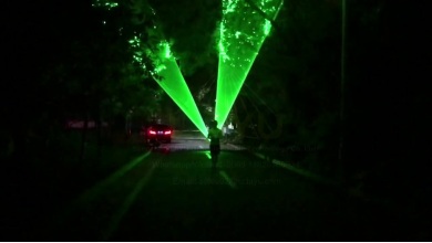 Green laser light outdoor performance in a park